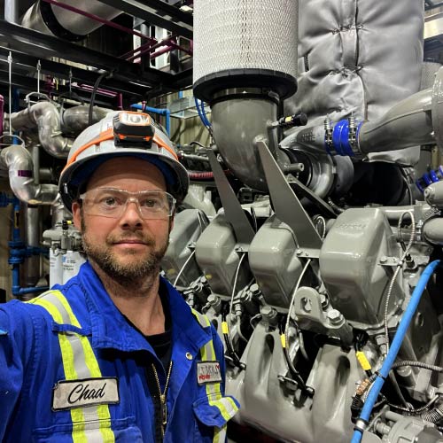 Chad Leroux checking the piston in a Diesel Engiine at the remote location.